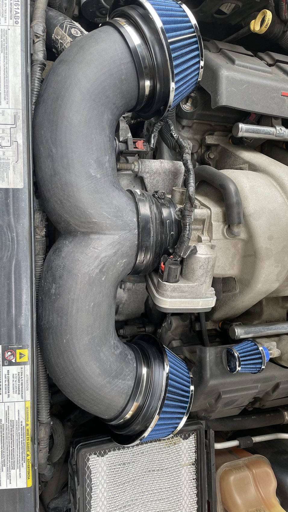 Dual cone filter intake routing installed in a Dodge Magnum engine bay