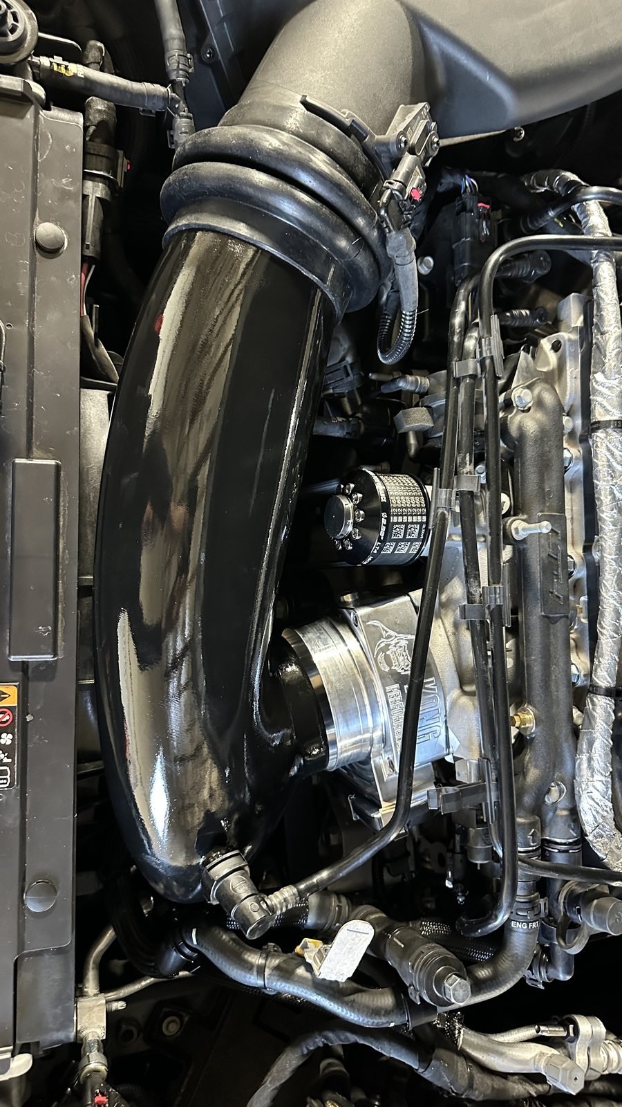 Black intake tube and sensor placement in a Cadillac CT5-V Blackwing engine bay